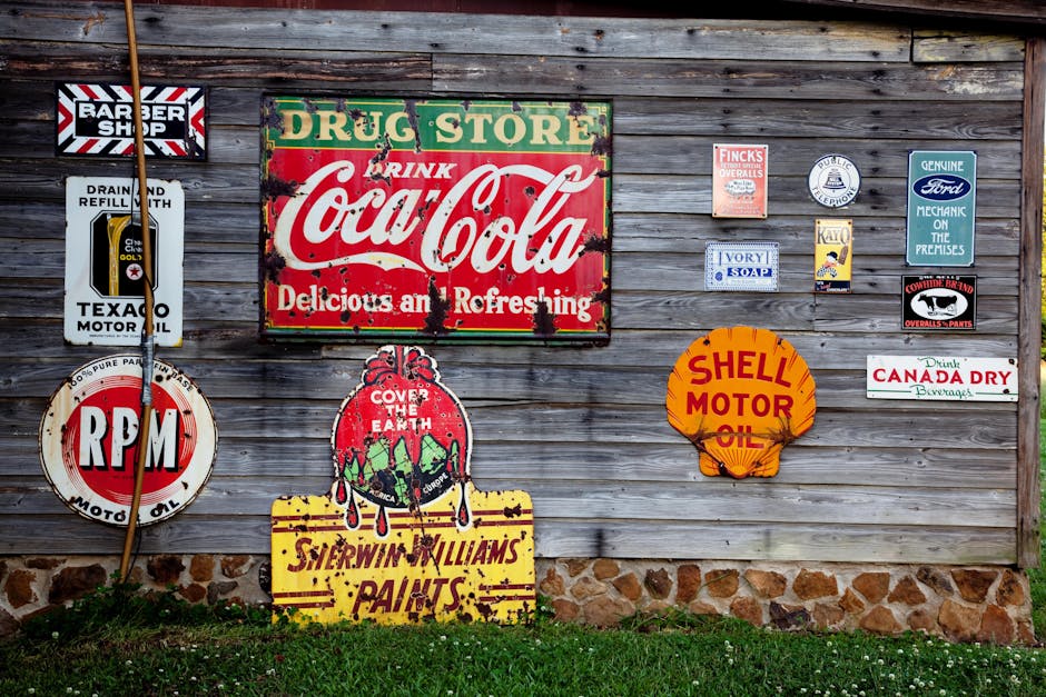 Collection of vintage advertising signs on rustic wooden wall showcasing classic brands