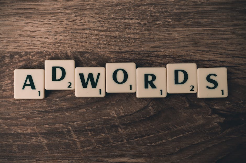 Scrabble tiles spelling 'AdWords' on a wooden surface, symbolizing digital marketing concepts