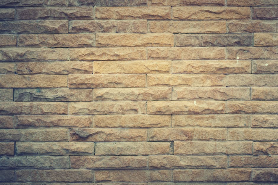 Rustic brown brick wall with textured pattern, perfect for backgrounds and design elements